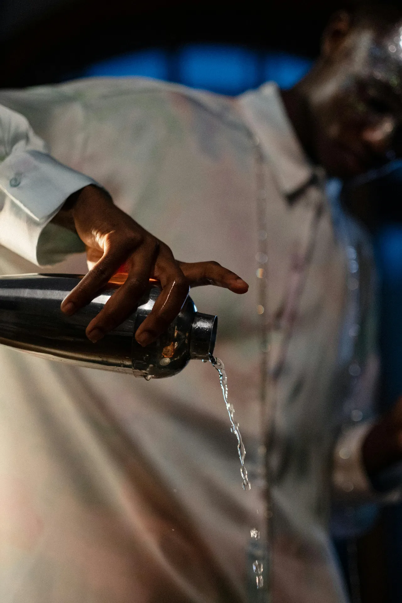 Bartender pouring from a cocktail shaker
