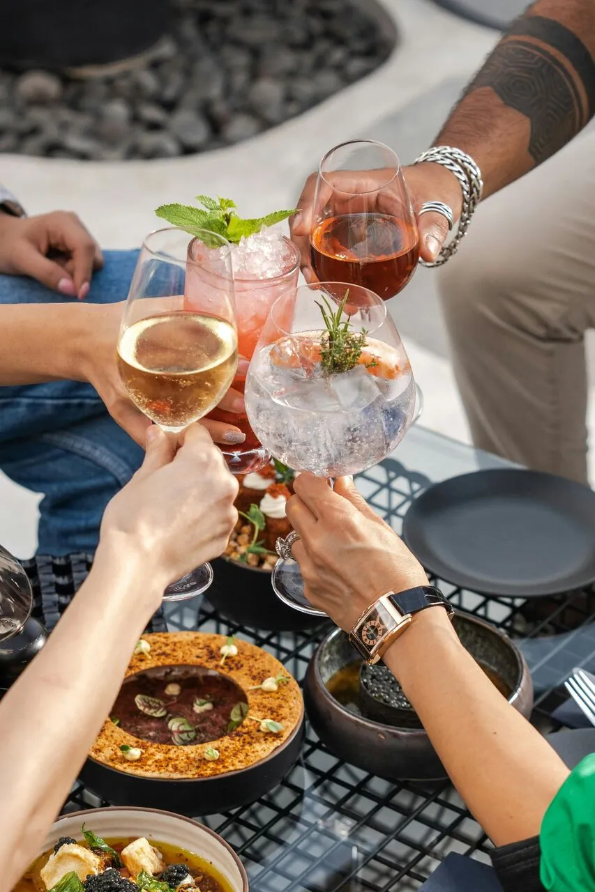 Friends raising glasses around a shared table