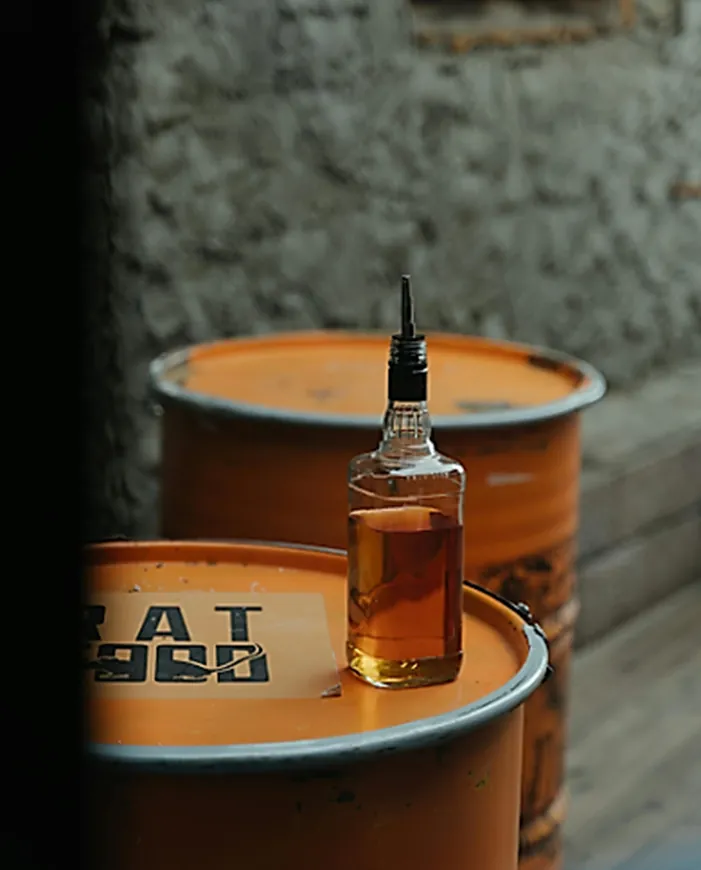 Whiskey bottle on barrels